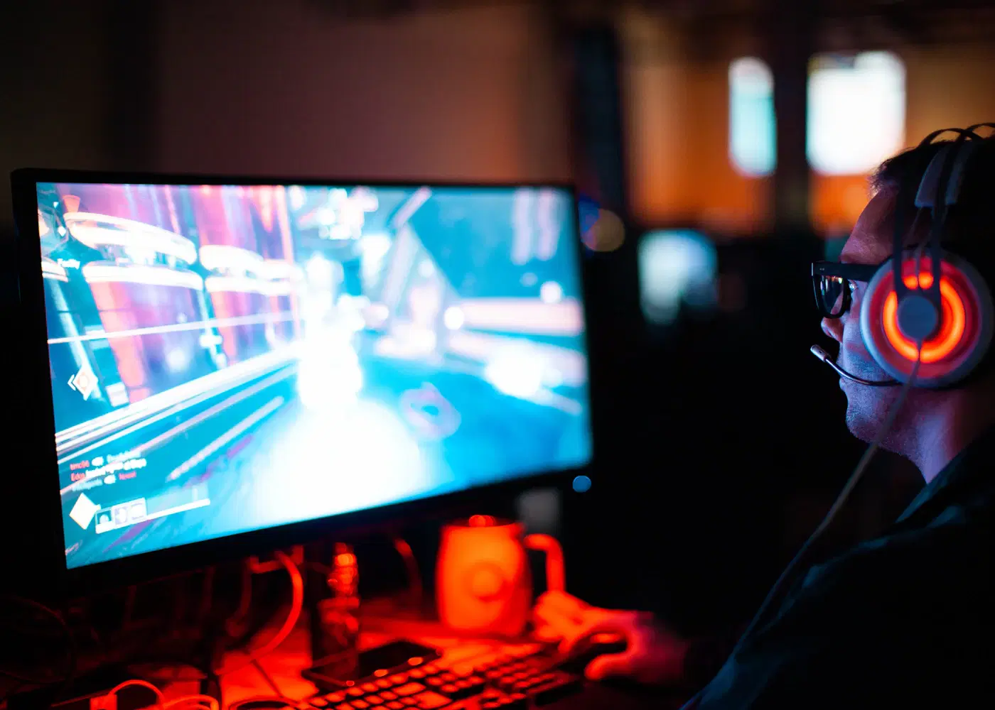 Player competing in FPS game on gaming monitor